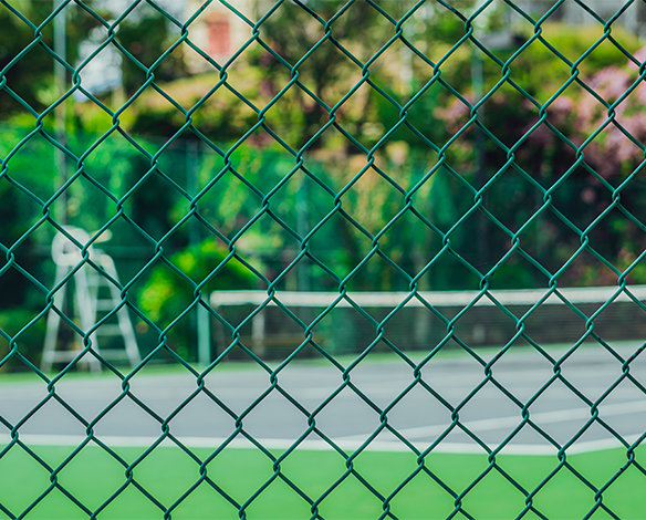 Green chain link fence around tennis court